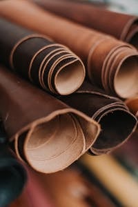 Detailed close-up of neatly rolled leather pieces, perfect for craft and design projects.